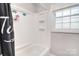 Clean, well-maintained bathroom featuring a shower-tub combo with built-in shelving and a bright window at 2825 Old Pageland Marshville Rd, Wingate, NC 28174