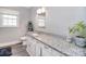 A bright bathroom features a granite countertop, white cabinets, and a view from two windows at 2825 Old Pageland Marshville Rd, Wingate, NC 28174
