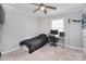 A cozy bedroom features neutral walls, ceiling fan, and a built-in desk area for work or gaming at 2825 Old Pageland Marshville Rd, Wingate, NC 28174