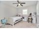 Bright bedroom features neutral walls, ceiling fan, cozy twin bed, and a charming vanity desk at 2825 Old Pageland Marshville Rd, Wingate, NC 28174