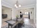 Open dining area with a modern table set, views to the kitchen, and hardwood floors at 2825 Old Pageland Marshville Rd, Wingate, NC 28174