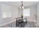 Bright dining area with hardwood floors, a chandelier, and views of backyard through windows at 2825 Old Pageland Marshville Rd, Wingate, NC 28174