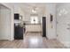 White kitchen with stainless steel appliances, patterned backsplash, and hardwood floors at 2825 Old Pageland Marshville Rd, Wingate, NC 28174