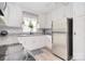 Bright kitchen featuring a stainless steel fridge, patterned backsplash, and granite countertops at 2825 Old Pageland Marshville Rd, Wingate, NC 28174
