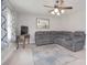 Bright living room features a ceiling fan, area rug and gray sectional sofa at 2825 Old Pageland Marshville Rd, Wingate, NC 28174