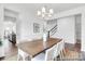 Elegant dining room showcasing a wooden table, six chairs, a chandelier, and decorative wall trim at 36131 Greg Norman Dr # 1031, Lancaster, SC 29720