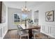 Formal dining room with wainscoting, wood table, and a view of the backyard through a large window at 36131 Greg Norman Dr # 1031, Lancaster, SC 29720