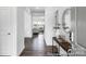 Inviting hallway with dark wood floors, light walls, and a view into the light filled living room at 36131 Greg Norman Dr # 1031, Lancaster, SC 29720
