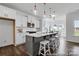 Modern kitchen with white cabinets, subway tile backsplash, island with bar seating, and stainless appliances at 36131 Greg Norman Dr # 1031, Lancaster, SC 29720