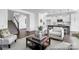Open-concept living room adjacent to a kitchen with stairs and modern decor, with ample seating at 36131 Greg Norman Dr # 1031, Lancaster, SC 29720