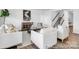 Bright living room boasts modern furnishings, a unique pelican painting, and easy access to the staircase at 36131 Greg Norman Dr # 1031, Lancaster, SC 29720