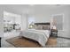 Serene main bedroom featuring plush bedding, neutral tones, and an open view into the sun room at 36131 Greg Norman Dr # 1031, Lancaster, SC 29720