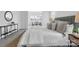 Bright and airy main bedroom with soft gray bedding, a stylish side table, and a cozy rug at 36131 Greg Norman Dr # 1031, Lancaster, SC 29720