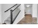 Carpeted staircase with dark wood railings, offering a seamless transition between floors and an open entryway at 36131 Greg Norman Dr # 1031, Lancaster, SC 29720