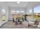 Bright sun room with ample windows, stylish seating, and a cozy atmosphere for relaxation with a view to the backyard at 36131 Greg Norman Dr # 1031, Lancaster, SC 29720