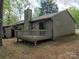 View of the back exterior features a deck, chimney, and serene outdoor space at 380 Sweetgum Dr, Fort Mill, SC 29715