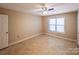 The bedroom has neutral walls, tile floors, ceiling fan, and a bright window at 380 Sweetgum Dr, Fort Mill, SC 29715