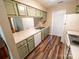 A quaint kitchen with wood floors, stainless steel sink and green painted cabinets at 380 Sweetgum Dr, Fort Mill, SC 29715