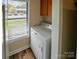 Bright laundry room with a white washer/dryer and a window view at 380 Sweetgum Dr, Fort Mill, SC 29715