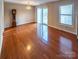 Sunlit living room with hardwood floors, sliding glass doors, and a wooden clock at 380 Sweetgum Dr, Fort Mill, SC 29715