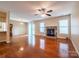 Sunlit living room with hardwood floors, a fireplace, a ceiling fan, and sliding glass doors at 380 Sweetgum Dr, Fort Mill, SC 29715