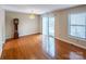 A spacious living room with hardwood floors, a sliding glass door, and a wooden clock at 380 Sweetgum Dr, Fort Mill, SC 29715