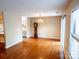 A warm living room with hardwood floors, access to the kitchen, and a sliding glass door at 380 Sweetgum Dr, Fort Mill, SC 29715