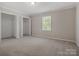 Bright bedroom features neutral carpet, a window, and large closets with bi-fold doors at 405 N Wilson St # 103, Rock Hill, SC 29730