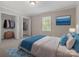 Staged bedroom features a cozy bed, window, and closets with ample storage at 405 N Wilson St # 103, Rock Hill, SC 29730