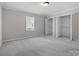 Bright bedroom features neutral carpet, a window, and large closets with bi-fold doors at 405 N Wilson St # 103, Rock Hill, SC 29730