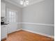 Hardwood dining room with white trim and a door with decorative glass panels at 405 N Wilson St # 103, Rock Hill, SC 29730