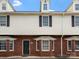 Exterior view of a two-story townhome with brick and siding, showcasing its classic architecture at 405 N Wilson St # 103, Rock Hill, SC 29730