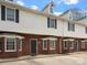 Exterior shot of a brick and vinyl townhome with black shutters and black front door at 405 N Wilson St # 103, Rock Hill, SC 29730