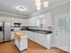 Bright kitchen featuring white cabinetry, stainless steel appliances, and a movable island at 405 N Wilson St # 103, Rock Hill, SC 29730