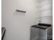 Bright laundry area featuring modern washer, coat rack, and ample storage shelving at 405 N Wilson St # 103, Rock Hill, SC 29730