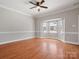 Empty living room with beautiful floors, crown molding, a ceiling fan, and large windows at 405 N Wilson St # 103, Rock Hill, SC 29730