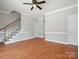 Expansive living area showcasing hardwood flooring, a staircase, and fresh, neutral wall colors at 405 N Wilson St # 103, Rock Hill, SC 29730