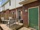 Patio with furniture, brick exterior, an air conditioner, and a green door at 405 N Wilson St # 103, Rock Hill, SC 29730