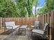 Outdoor patio featuring patio furniture, a wooden fence, and mature trees at 405 N Wilson St # 103, Rock Hill, SC 29730