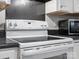 Kitchen view showcasing a white range oven with black countertops and a microwave at 405 N Wilson St # 103, Rock Hill, SC 29730