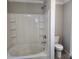 Bright bathroom featuring a tub with shower and tiled walls, next to a white toilet at 4168 S Olivers Cross Rd # 6, Newton, NC 28658