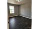 Bedroom with dark hardwood floors, freshly painted walls, and a window at 4168 S Olivers Cross Rd # 6, Newton, NC 28658