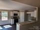 Modern kitchen featuring white cabinets, granite countertops, stainless steel appliances, and ample natural light, perfect for cooking at 4168 S Olivers Cross Rd # 6, Newton, NC 28658