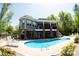 Expansive backyard with a beautiful pool, lounge chairs, and lush greenery, ideal for outdoor enjoyment at 447 Shagbark Ct, Mount Gilead, NC 27306