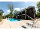 Gorgeous backyard showcasing a sparkling pool and an expansive multi-story brick home at 447 Shagbark Ct, Mount Gilead, NC 27306