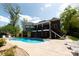 Expansive backyard with a large pool, covered patio, and multi-story home at 447 Shagbark Ct, Mount Gilead, NC 27306