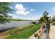 Scenic lake view with lush landscaping and a covered dock at 447 Shagbark Ct, Mount Gilead, NC 27306