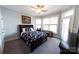 Serene bedroom featuring a dark wood bed frame and ample natural light at 447 Shagbark Ct, Mount Gilead, NC 27306