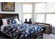 Cozy bedroom with floral bedding, window views, and ceiling fan at 447 Shagbark Ct, Mount Gilead, NC 27306