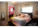 Cheerful pink bedroom with unique decor and comfy bedding at 447 Shagbark Ct, Mount Gilead, NC 27306